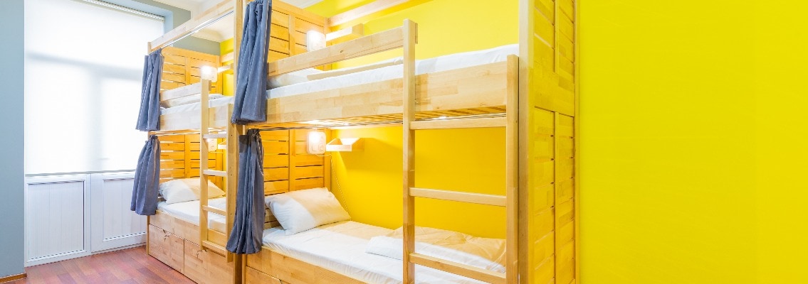 Hostel dormitory beds arranged in room