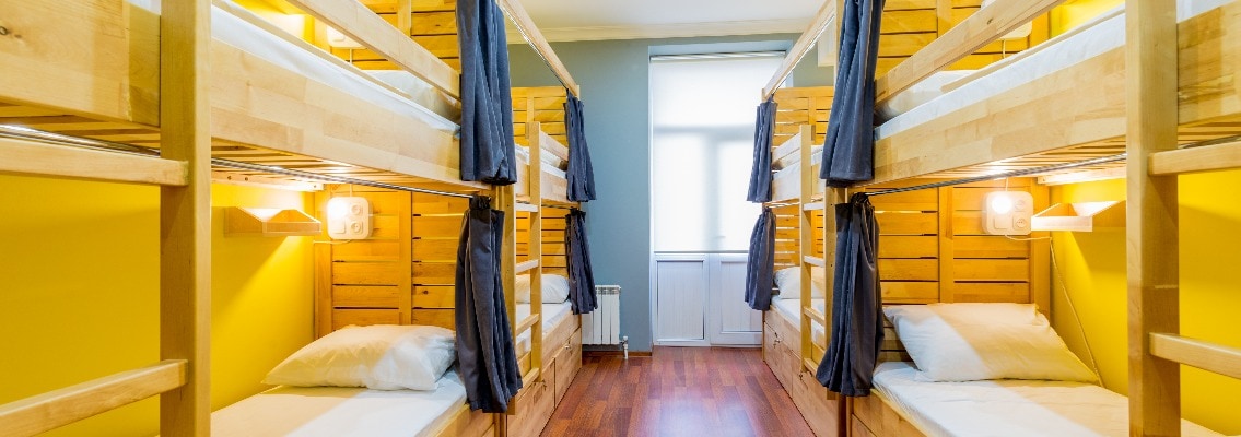 Hostel dormitory beds arranged in room