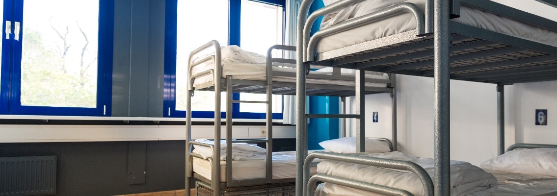 Hostel interior, bunk beds and linen, nobody