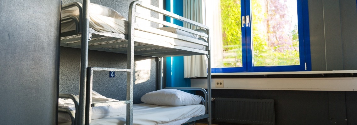 Hostel interior, metal bunk beds and linen, nobody